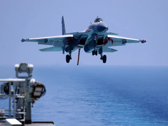 J15 fighter jet preparing to land on China's sole operational aircraft carrier, the Liaoning, during a drill at sea.