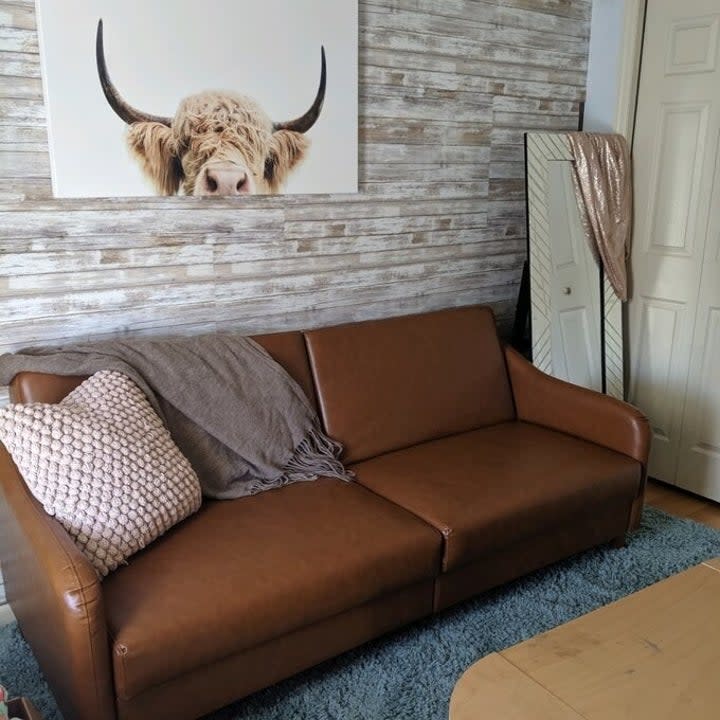 a reviewer photo of the brown sofa