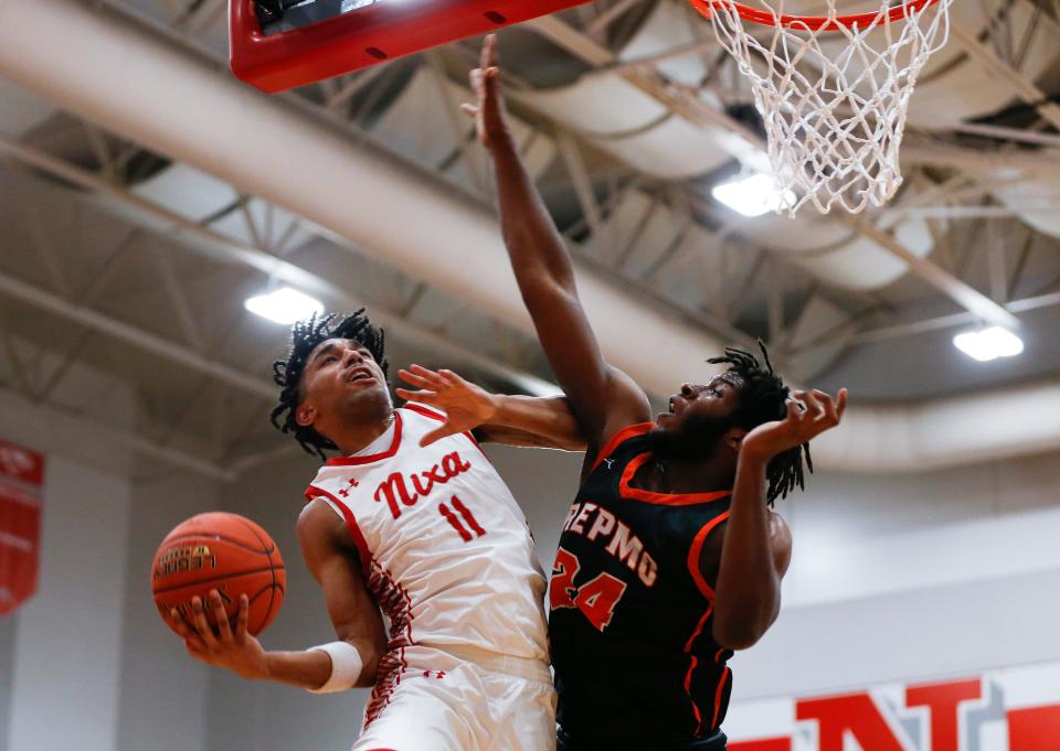Nixa's Kael Combs tosses up a field goal as Republic's Khamari Edwards attempts to block the shot as the Eagles take on the Tigers during a game on Tuesday, Feb. 7, 2023.