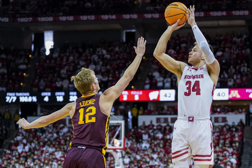 Wisconsin's Brad Davison (34) shoots against Minnesota's Luke Loewe (12) during the second half of an NCAA college basketball game Sunday, Jan. 30, 2022, in Madison, Wis. Wisconsin won 66-60. (AP Photo/Andy Manis)