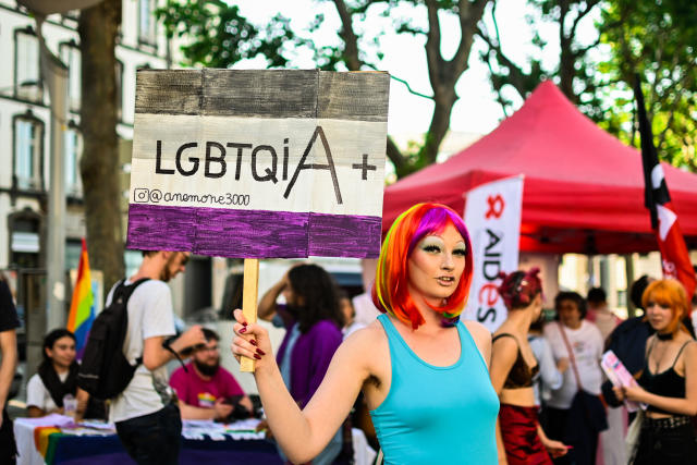 A person holds a sign reading ''LGBTQIA+'', in Paris, France, on June 3, 2022. A night Pride was organized in Clermont-Ferrand, by several unions and associations supporting the LGBT+ cause. (Photo by Adrien Fillon/NurPhoto via Getty Images)