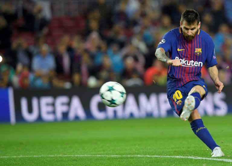 Barcelona's Lionel Messi shoots to score his goal number 100 in a European competition during their UEFA Champions League match against Olympiacos FC at the Camp Nou stadium in Barcelona on Ocotber 18, 2017