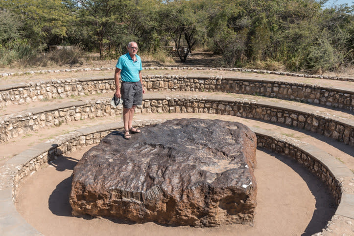 A man standing on the meteorite