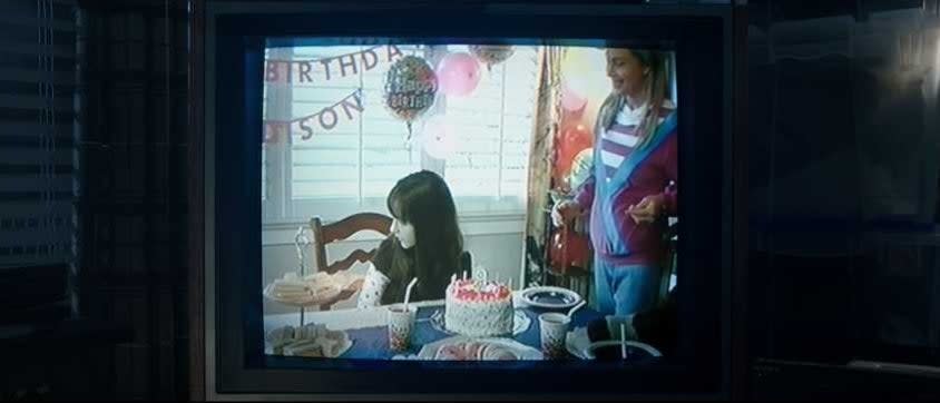 Old VHS tape of girl's birthday party being played on a TV