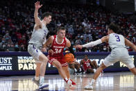 Wisconsin guard Brad Davison, center, drives to the basket against Northwestern forward Robbie Beran, left, and guard Ty Berry during the first half of an NCAA college basketball game in Evanston, Ill., Tuesday, Jan. 18, 2022. (AP Photo/Nam Y. Huh)