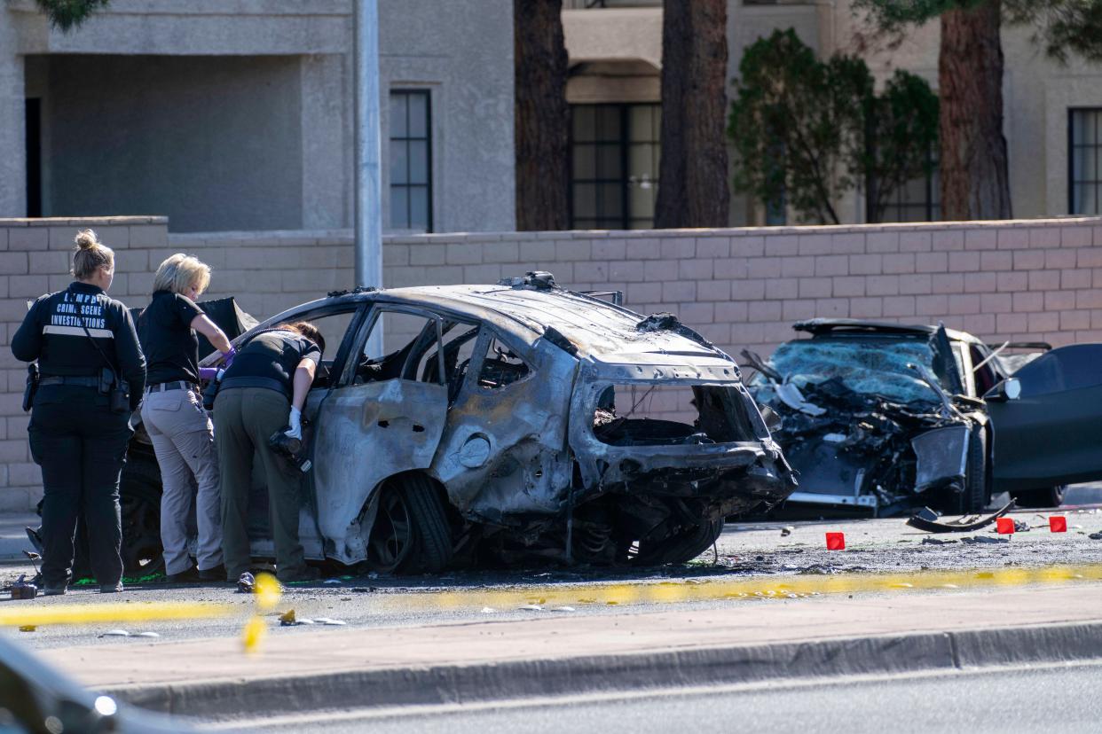 Las Vegas Metro Police investigators work at the scene of a fatal crash involving Las Vegas Raiders wide receiver Henry Ruggs.