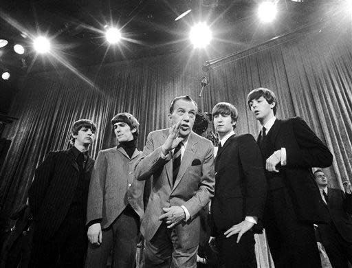 In this Feb. 9, 1964 file photo, Ed Sullivan, center, stands with The Beatles, from left, Ringo Starr, George Harrison, John Lennon, and Paul McCartney, during a rehearsal for the British group's first American appearance, on the &quot;Ed Sullivan Show,&quot; in New York.