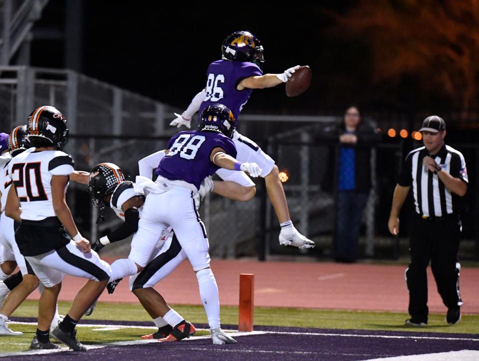 Wylie wide receiver Hunter Hood leaps into the end zone, scoring a touchdown against El Paso during Class 5A first-round playoff game on Nov. 10 in Abilene. Wylie won 54-14.
