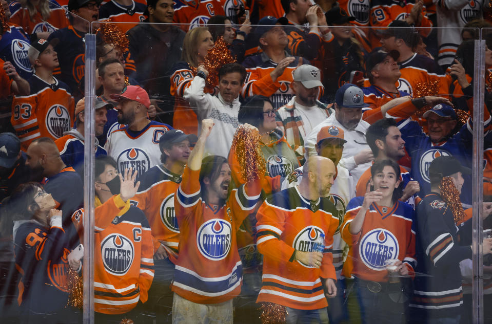 Edmonton Oilers fans cheer a goal against the Los Angeles Kings during the second period in Game 7 of a first-round series in the NHL hockey Stanley Cup playoffs Saturday, May 14, 2022, in Edmonton, Alberta. (Jeff McIntosh/The Canadian Press via AP)