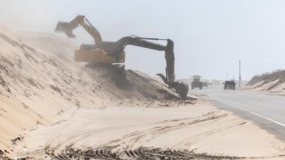 NC DOT crews clear sand along highway NC 12 on Pea Island Thursday, Sept. 14, 2023 as Hurricane Lee churns on a Northward track hundreds of miles offshore in the Atlantic. Travis Long/tlong@newsobserver.com