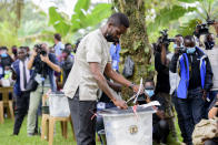 Uganda's leading opposition challenger Bobi Wine casts his vote in Kampala, Uganda, Thursday, Jan. 14, 2021. Ugandans are voting in a presidential election tainted by widespread violence that some fear could escalate as security forces try to stop supporters of Wine from monitoring polling stations.(AP Photo/Nicholas Bamulanzeki)