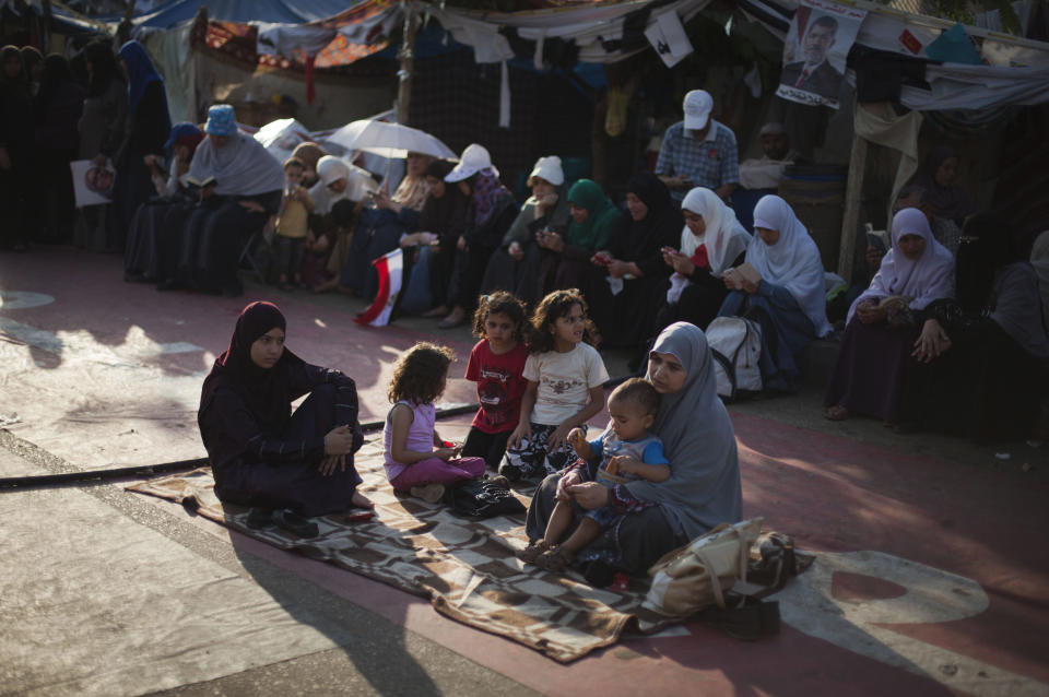 Supporters of Egypt's ousted President Mohammed Morsi sit outside Rabaah al-Adawiya mosque, where protesters have installed a camp and hold daily rallies at Nasr City in Cairo, Egypt, Thursday, Aug. 1, 2013. (AP Photo/Khalil Hamra)