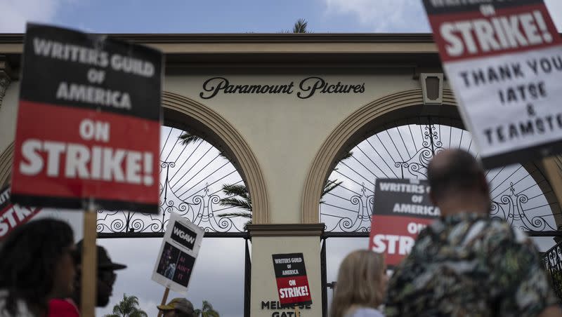 Demonstrators walk with signs during a rally outside the Paramount Pictures Studio in Los Angeles on Sept. 21, 2023. A tentative deal was reached on Sunday, Sept. 24, 2023, to end Hollywood’s writers strike after nearly five months.