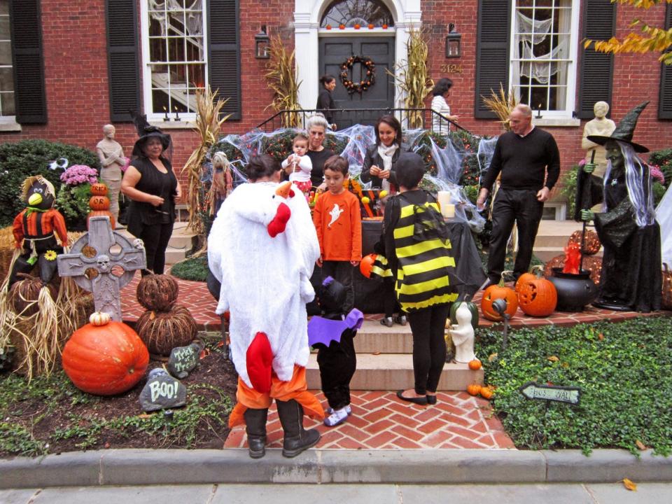 Washington DC, USA-October 31, 2013: Trick and treaters show up for free candy at a home in Georgetown of Washington DC. Halloween is a big event here.