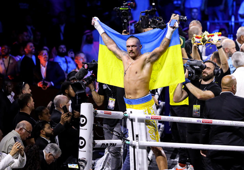 Oleksandr Usyk (pictured) holds up the flag of Ukraine after defeating Anthony Joshua.