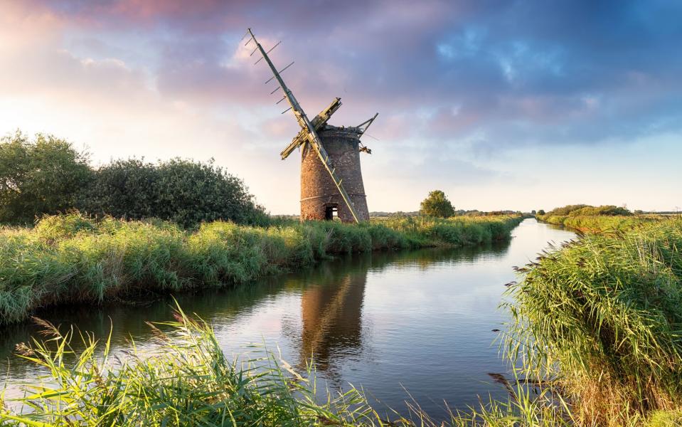 A derelict windmill crumbles away on the banks of the Norfolk Broads - AP/FOTOLIA