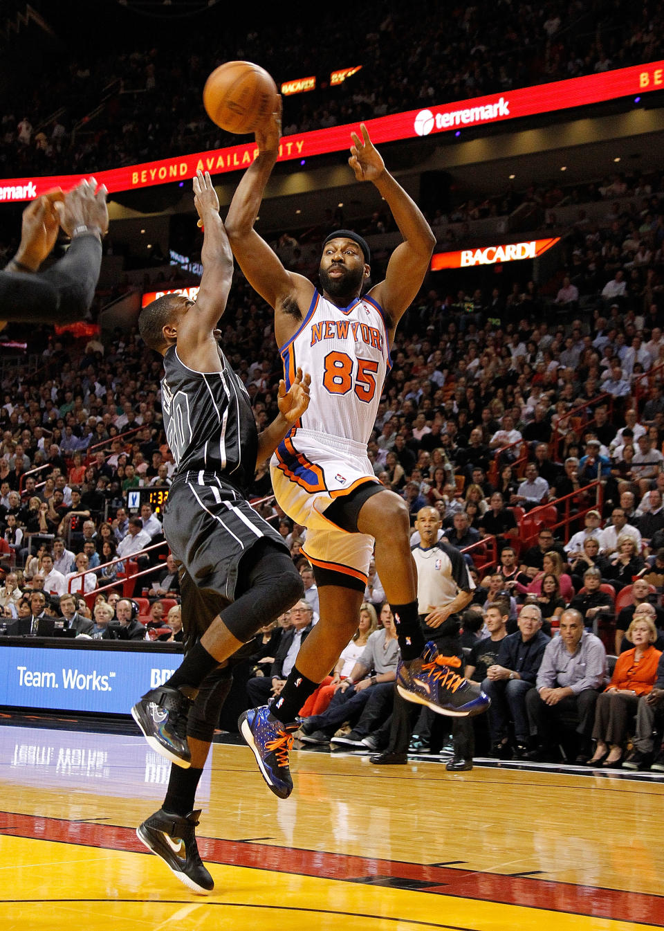 MIAMI, FL - FEBRUARY 23: Baron Davis #85 of the New York Knicks passes over Norris Cole #30 of the Miami Heat during a game at American Airlines Arena on February 23, 2012 in Miami, Florida. NOTE TO USER: User expressly acknowledges and agrees that, by downloading and/or using this Photograph, User is consenting to the terms and conditions of the Getty Images License Agreement. (Photo by Mike Ehrmann/Getty Images)