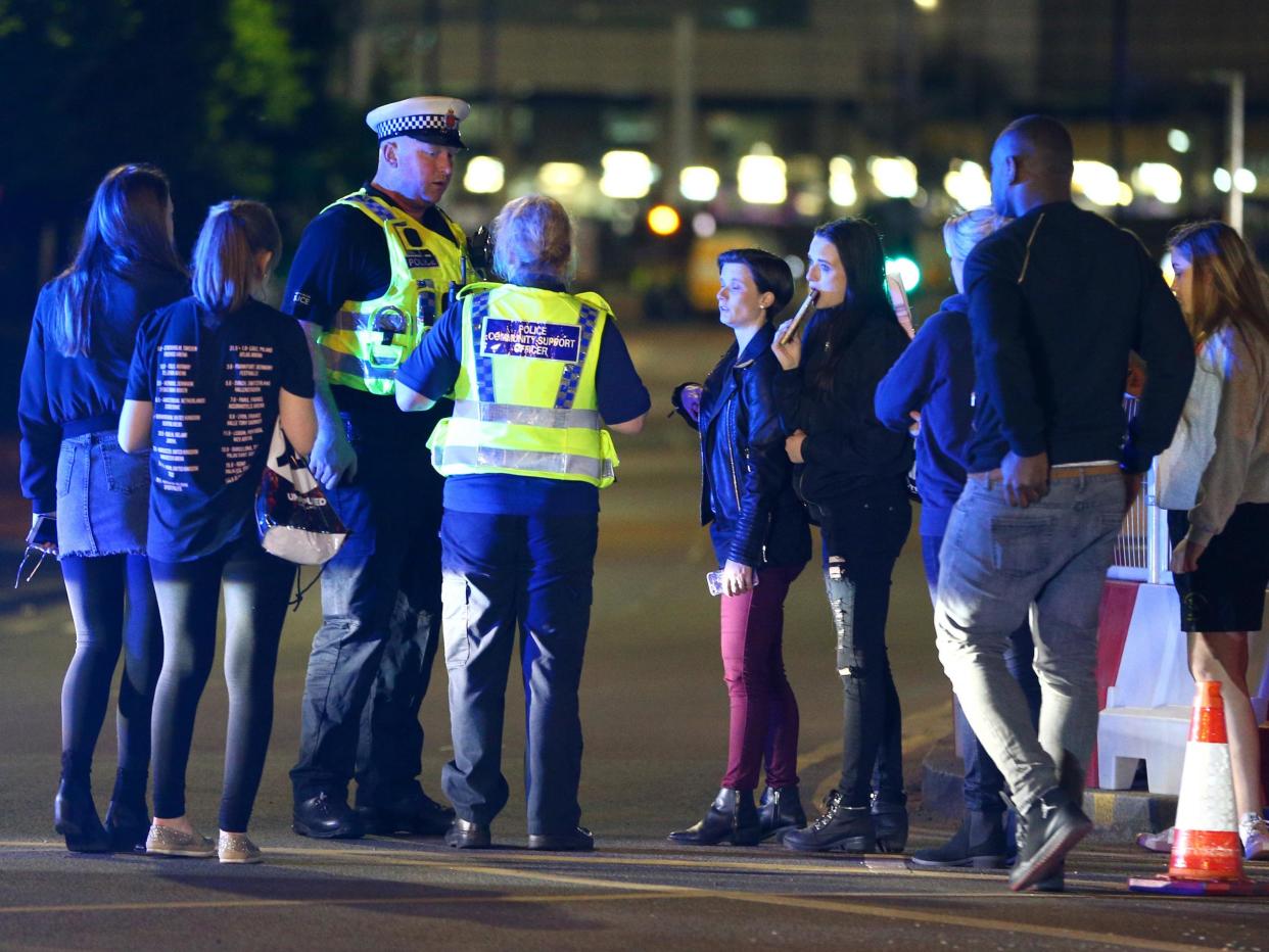 Survivors with police outside the Manchester Arena, where a suicide bomber killed and injured gig-goers on Monday night: Getty Images