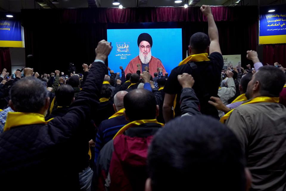Supporters of the Iranian-backed Hezbollah group raise their fists and cheer as they listen to a speech by Hezbollah leader Sayyed Hassan Nasrallah via a video link, during a rally to mark the "Wounded Resistance Day," in the southern Beirut suburb of Dahiyeh, Lebanon, Monday, March 6, 2023. The leader of Lebanon’s militant Hezbollah group said Monday that they back former Cabinet minister and strong ally Sleiman Frangieh to become Lebanon’s next president. (AP Photo/Bilal Hussein)