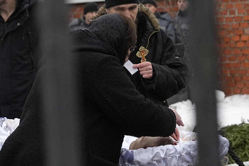 Russian Opposition Leader Alexei Navalny's mother Lyudmila Navalnaya pays last respects next to the open casket of her son at the Borisovskoye Cemetery, in Moscow, Russia, Friday, March 1, 2024. Under a heavy police presence, thousands of people bade farewell Friday to Alexei Navalny at his funeral in Moscow after his still-unexplained death two weeks ago in an Arctic penal colony. (AP Photo)