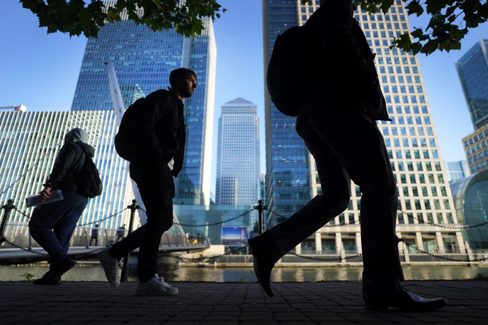 Office workers and commuters walk through Canary Wharf in London during the morning rush hour. Picture date: Wednesday October 6, 2021.