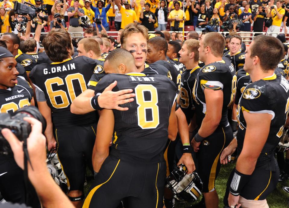 Missouri quarterback Blaine Gabbert, center, hugs teammate Wes Kemp (8) after they defeated Illinois 23-13 in an NCAA college football game Saturday, Sept. 4, 2010, in St. Louis.