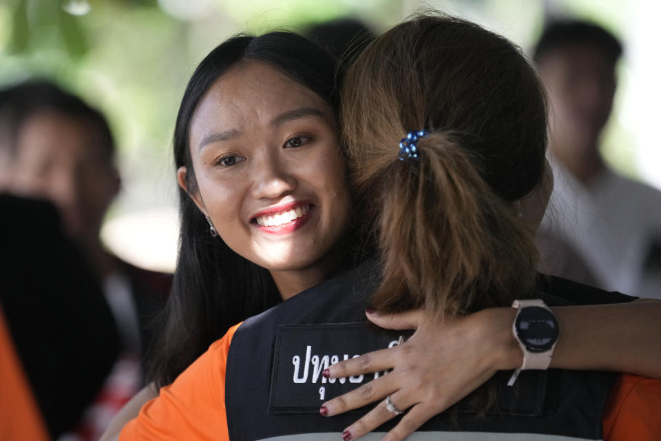 Move Forward Party's Chonthicha Jangrew, left, hugs her supporter on her arrival at the Thanyaburi Provincial Court in Pathum Thani province, north of Bangkok, Thailand, Monday, May 27, 2024. The Thai court on Monday sentenced the lawmaker from the progressive opposition party to two years in prison after finding her guilty of defaming the monarchy in a speech she made during a protest rally three years ago. (AP Photo/Sakchai Lalit)