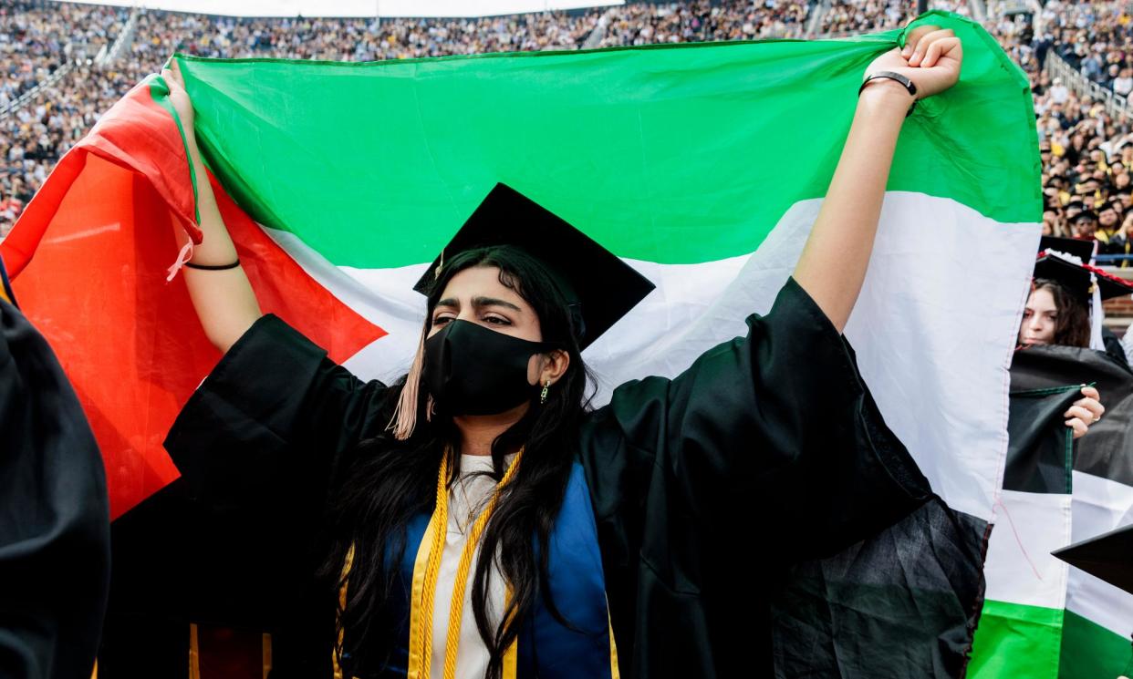 <span>A protester at Michigan Stadium in Ann Arbor, Michigan, on 4 May 2024.</span><span>Photograph: Jacob Hamilton | MLive.com/AP</span>