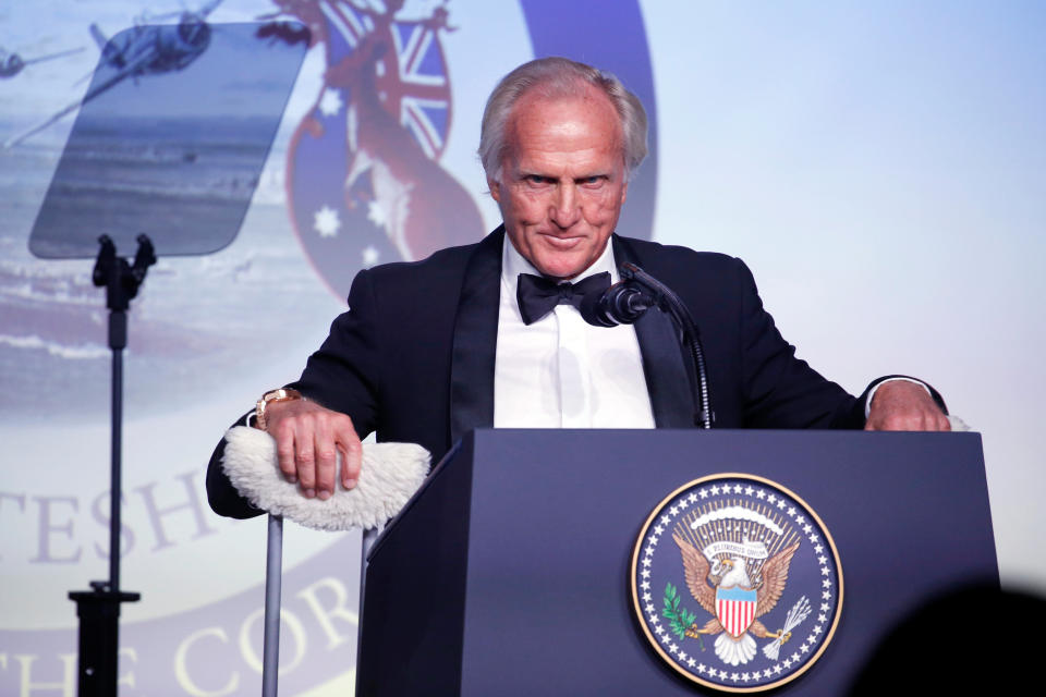 Former golfer Greg Norman of Australia takes up his crutches to leave the stage after delivering remarks at an event commemorating the 75th anniversary of the Battle of the Coral Sea, aboard the USS Intrepid Sea, Air and Space Museum in New York, U.S. May 4, 2017. REUTERS/Jonathan Ernst