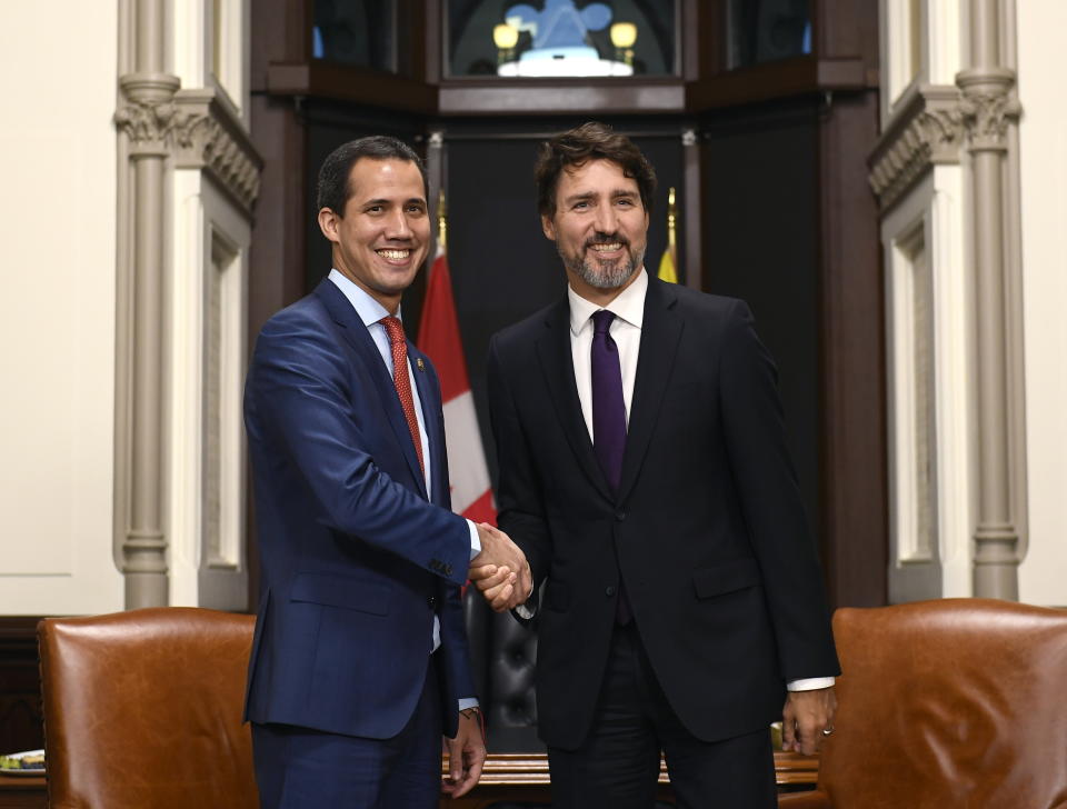 Canada's Prime Minister Justin Trudeau, right, and interim President of Venezuela Juan Guaido shake hands before a meeting at Trudeau's Parliament Hill office in Ottawa, Ontario, Monday, Jan. 27, 2020. (Justin Tang/The Canadian Press via AP)