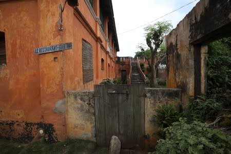 Sign of a restaurant and bar is seen on the wall of the old English fort in the historic slave town of Ouidah