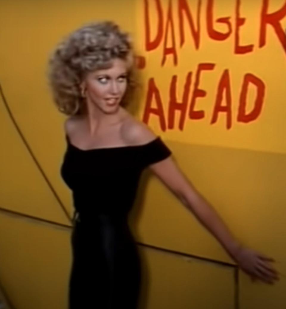 Olivia Newton-John as Sandy sings "You're The One That I Want" at the end-of-the-year school carnival
