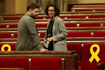 Marta Rovira (R), General Secretary of Republican Left of Catalonia (ERC), talks to ERC's deputy Gabriel Rufian before the start of the first session of Catalan Parliament after the regional elections in Barcelona, Spain, January 17, 2018. REUTERS/Albert Gea