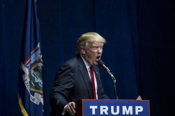 At an April 2016 rally, then-candidate Trump prepares to swallow a microphone whole in a performance art bit.