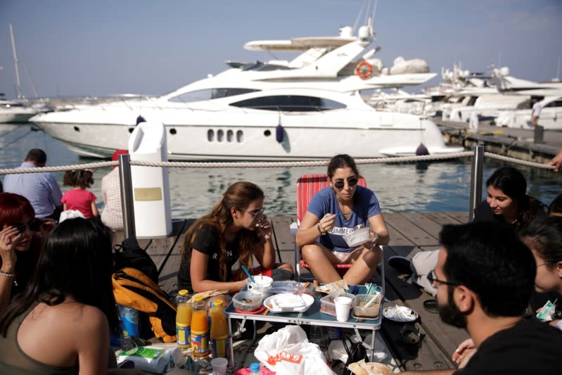 Protesters take part in the ongoing anti-government protests in Beirut