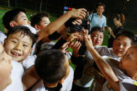 <p>Eagles players celebrate after they defeated the Sharklets in a Future League American football youth league match in Beijing, May 26, 2017. (Photo: Thomas Peter/Reuters) </p>