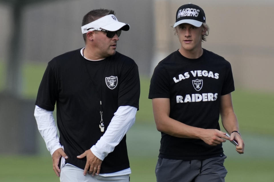 Las Vegas Raiders head coach Josh McDaniels, left, watches during NFL football training camp, Friday, July 22, 2022, in Henderson, Nev. (AP Photo/John Locher)
