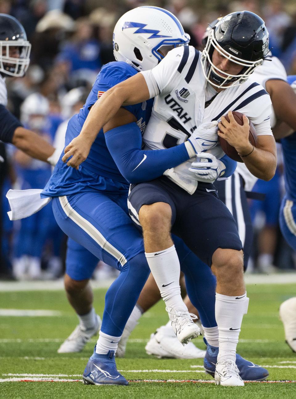 Air Force linebacker PJ Ramsey, front left, sacks Utah State quarterback Cooper Legas, right, during the first half of an NCAA college football game in Air Force Academy, Colo., Friday, Sept. 15, 2023. | Christian Murdock/The Gazette via AP