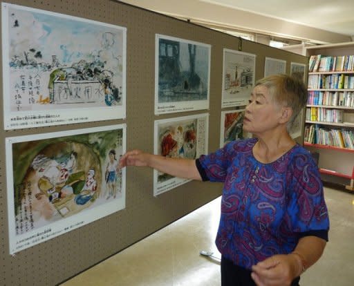 Misako Katani displays a painting illustrating the horror of nuclear bombings in Hiroshima's city hall on August 1, 2010. Katani said that images of the Fukushima nuclear crisis reminded her of the horror of living through both atomic bombings of Japan