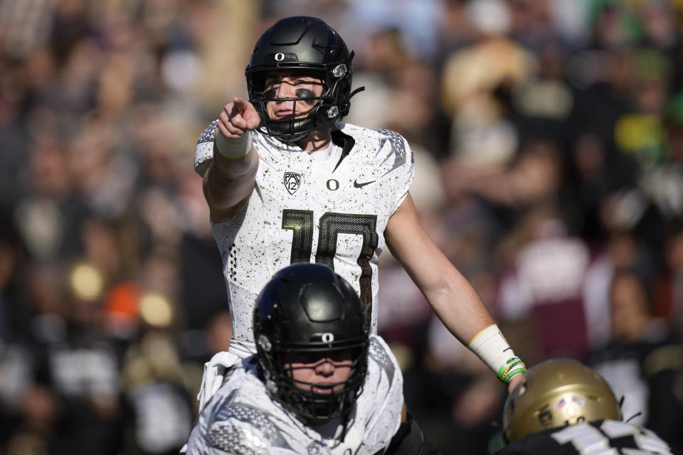 Oregon quarterback Bo Nix directs players at the line of scrimmage against Colorado on Saturday, Nov. 5, 2022, in Boulder, Colo. (AP Photo/David Zalubowski)