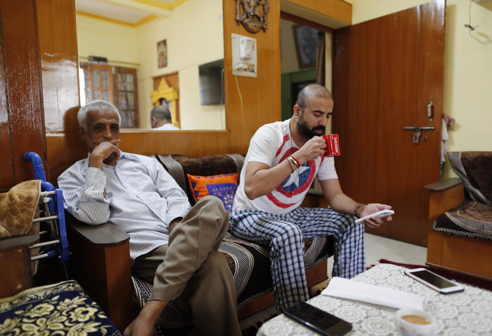 Radha Gobindo Pramanik sits beside his son-in-law days after both his wife and daughter died of the coronavirus in Lucknow, India, Friday June 4, 2021. Within days, Pramanisk's wife, his daughter and his unborn grandchild were among the tens of thousands killed as the coronavirus ravaged the country in April and May. As India emerges from its darkest days of the pandemic, families across the country are grieving all that they’ve lost and are left wondering if more could have been done to avoid this tragedy. (AP Photo/Rajesh Kumar Singh)