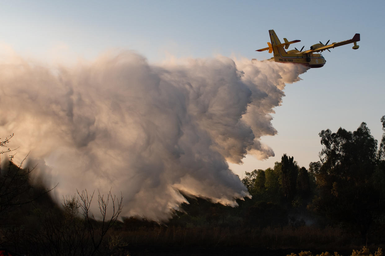 POSADA, ITALY - AUGUST 07: A Canadair aircraft attempts to extinguish a wildfire in Posada in the province of Nuoro on August 07, 2023 in Posada, Italy. A number of homes and resorts in the area have been evacuated as strong mistral winds help fuel the flames, being tackled by firefighting and civil protection teams along with helicopters and Canadair aircraft. (Photo by Emanuele Perrone/Getty Images)