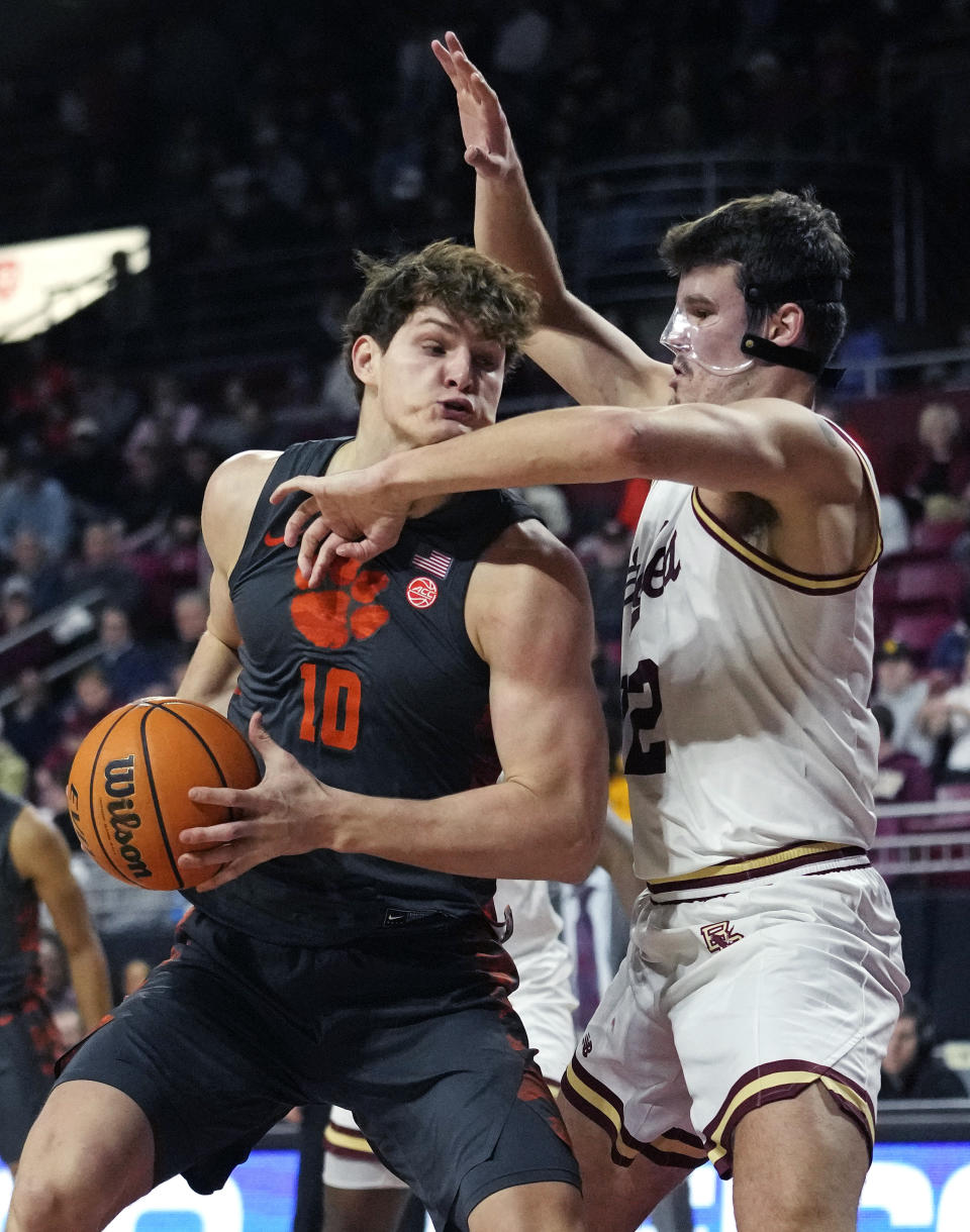 Clemson forward Ben Middlebrooks (10) drives to the basket against Boston College forward Quinten Post during the first half of an NCAA college basketball game, Tuesday, Jan. 31, 2023, in Boston. (AP Photo/Charles Krupa)