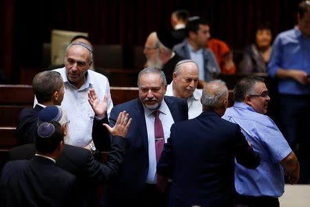 Avigdor Lieberman (C), head of far-right Yisrael Beitenu party is greeted as he arrives to the opening of the summer session of the Knesset, the Israeli parliament in Jerusalem, May 23, 2016. REUTERS/Ronen Zvulun
