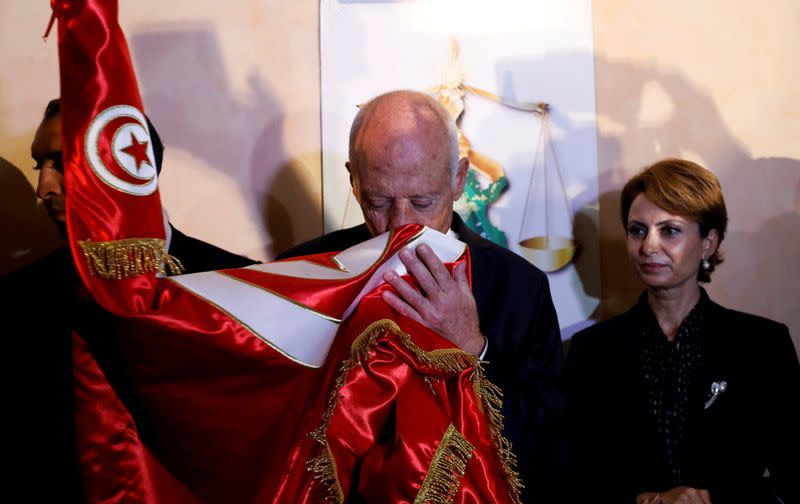 FILE PHOTO: Tunisian presidential candidate Kais Saied and his wife Ichraf Chebil react after exit poll results were announced in a second round runoff of the presidential election in Tunis