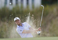 Daniel Berger, of the United States, watches his hit from the sand on the 6th hole during the final round of the Hero World Challenge PGA Tour at the Albany Golf Club, in New Providence, Bahamas, Sunday, Dec. 5, 2021.(AP Photo/Fernando Llano)