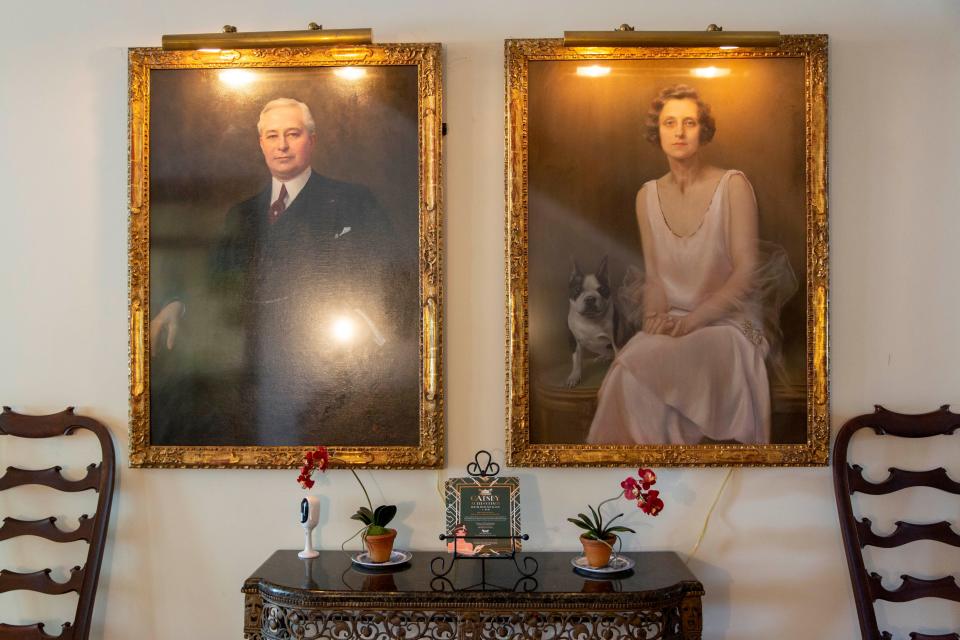 Portraits of Barron and Juliet Collier hang on the wall at historic Palm Cottage in Naples on Thursday, Feb. 20, 2020.