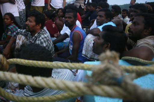 Photo illustration shows asylum-seekers from Sri Lanka sitting in their boat off Mentawai island, West Sumatra province. A group of Sri Lankans have chosen to return to their homeland rather than apply for asylum in Australia, where they faced being sent to a Pacific island for processing, the government said Saturday