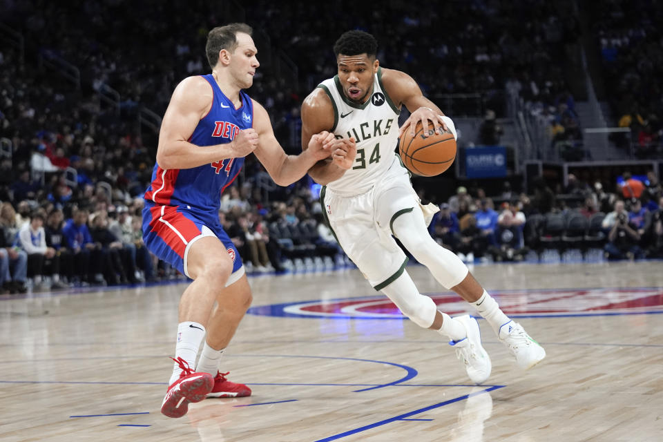 Milwaukee Bucks forward Giannis Antetokounmpo (34) drives on Detroit Pistons forward Bojan Bogdanovic (44) in the second half of an NBA basketball game in Detroit, Saturday, Jan. 20, 2024. (AP Photo/Paul Sancya)