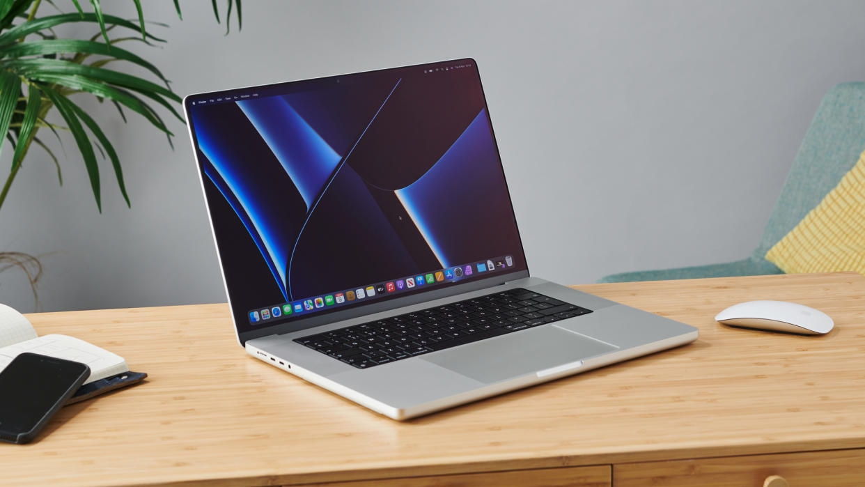  MacBook Pro 16-inch on wooden table in modern office. 